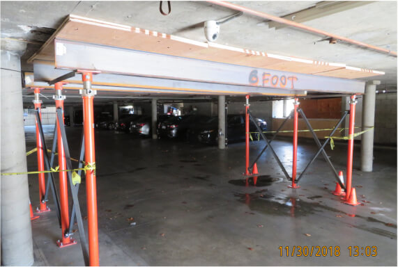 Temporary shoring beneath a parking slab