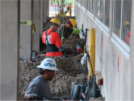 Pier installation along an excavated building wall